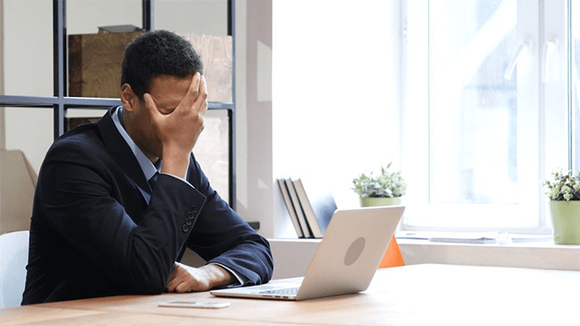 man sad while working on computer